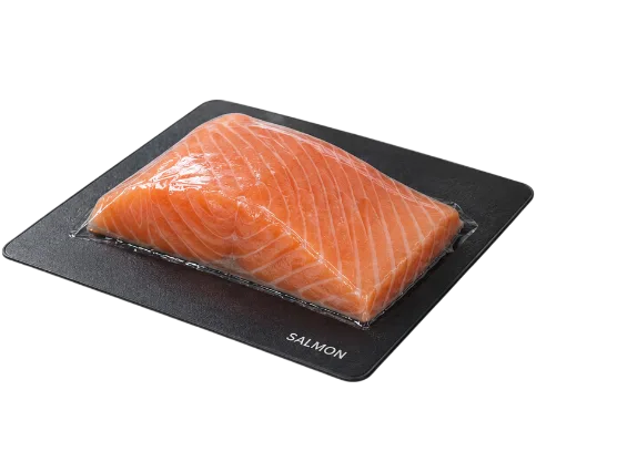 Salmon fillet skin packed on a black tray